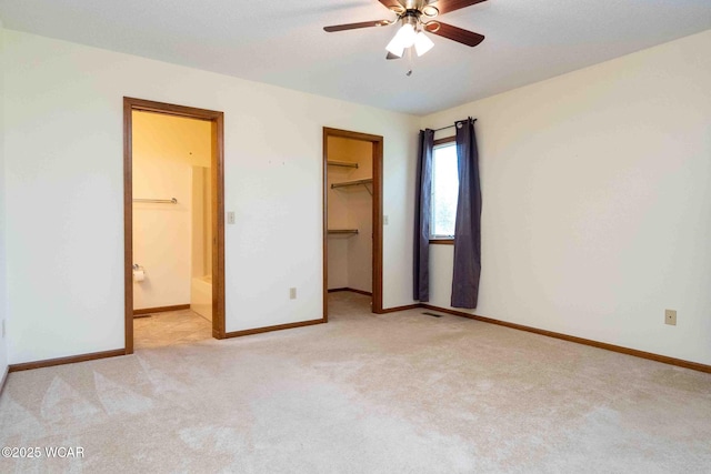 81 Riley Creek Ct, Bluffton, OH 45817 - unfurnished bedroom featuring light carpet, a walk in closet, ensuite bath, a closet, and ceiling fan