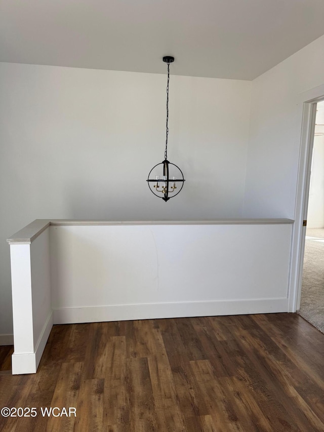 interior space featuring baseboards and wood finished floors