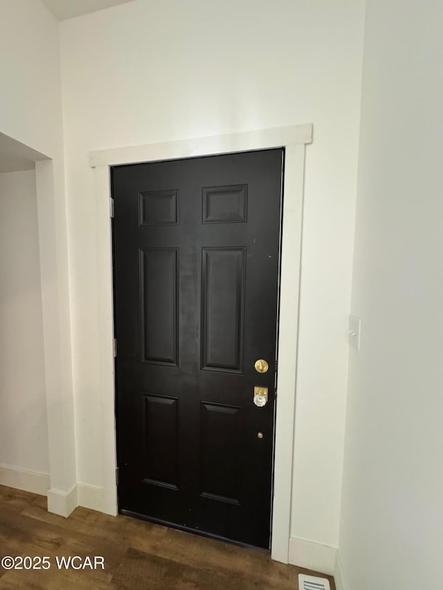 room details featuring baseboards and wood finished floors