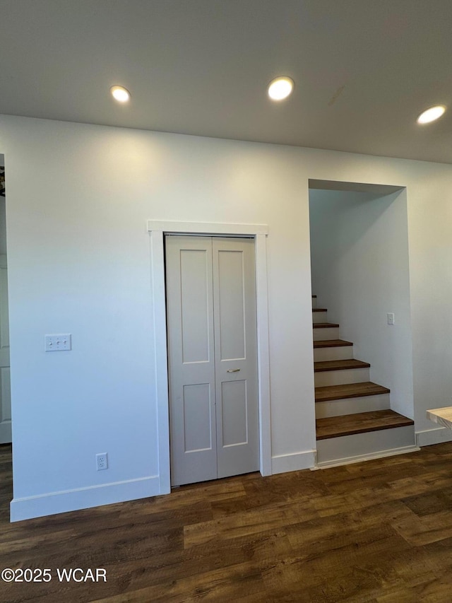 staircase featuring recessed lighting, wood finished floors, and baseboards