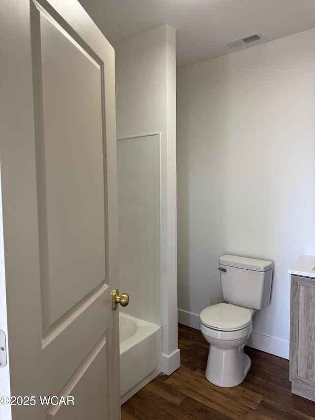 full bath with visible vents, toilet, wood finished floors, and vanity