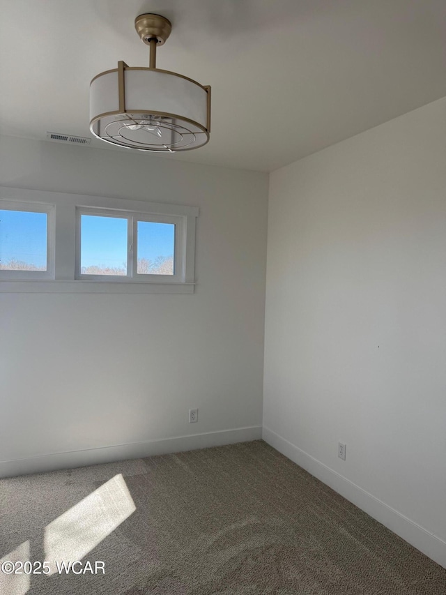 unfurnished room featuring visible vents, baseboards, and carpet floors