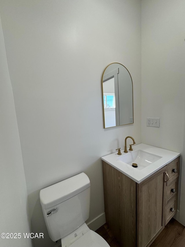 bathroom with toilet and vanity