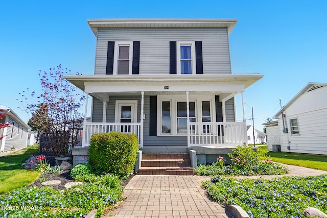 view of front of property featuring a porch and cooling unit