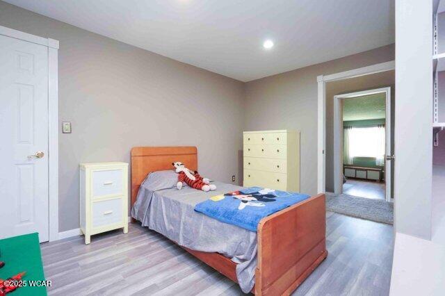 7560 Lugabill Rd, Bluffton, OH 45817 - bedroom with wood finished floors and recessed lighting