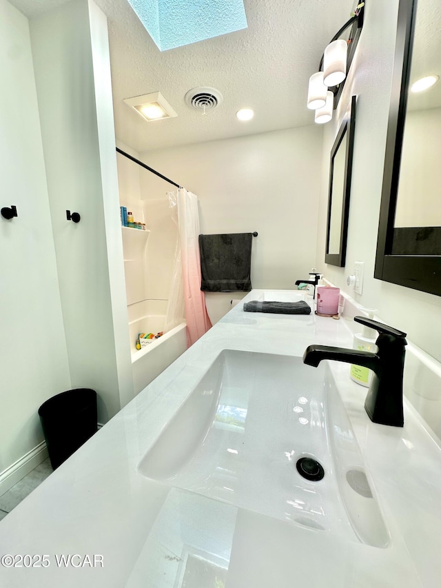 2969 Sands Rd, Lima, OH 45805 - bathroom featuring a textured ceiling, shower / bath combo, double vanity, a skylight, and recessed lighting