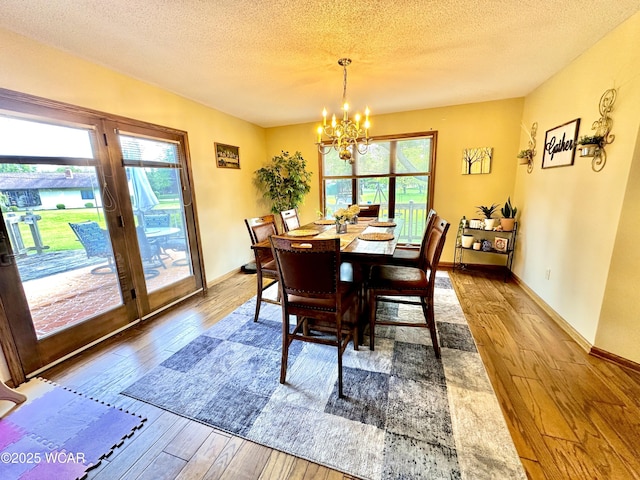 2969 Sands Rd, Lima, OH 45805 - dining area with hardwood / wood-style floors, a chandelier, plenty of natural light, a textured ceiling, and baseboards