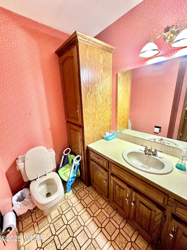 2969 Sands Rd, Lima, OH 45805 - bathroom with toilet, wallpapered walls, vanity, and a textured ceiling