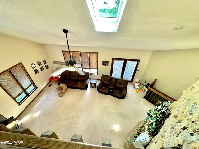 2969 Sands Rd, Lima, OH 45805 - living area with a skylight, vaulted ceiling, carpet, and ceiling fan