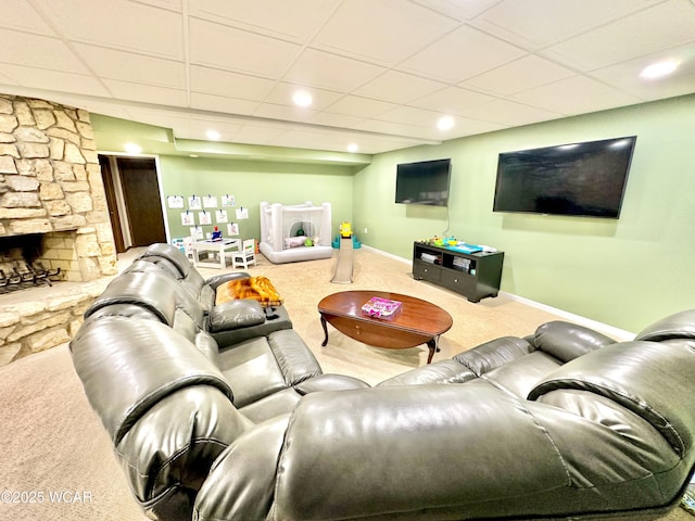 2969 Sands Rd, Lima, OH 45805 - living room featuring carpet flooring, baseboards, a paneled ceiling, and a stone fireplace