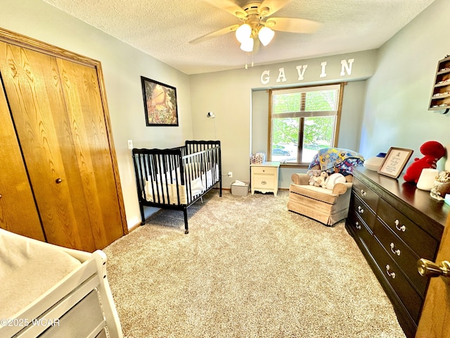 2969 Sands Rd, Lima, OH 45805 - carpeted bedroom with a textured ceiling, a crib, ceiling fan, and baseboards