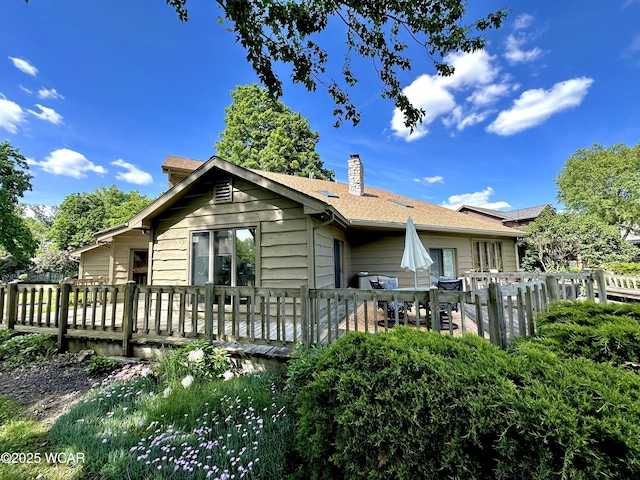 2969 Sands Rd, Lima, OH 45805 - view of side of property featuring a wooden deck, a chimney, and a shingled roof
