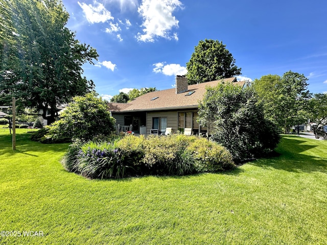 2969 Sands Rd, Lima, OH 45805 - view of side of property with a lawn and a chimney