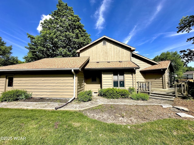 2969 Sands Rd, Lima, OH 45805 - ranch-style house with a front yard, a wooden deck, and roof with shingles