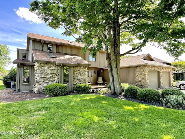 2969 Sands Rd, Lima, OH 45805 - view of front facade with stone siding, a front lawn, a garage, a shingled roof, and central air condition unit