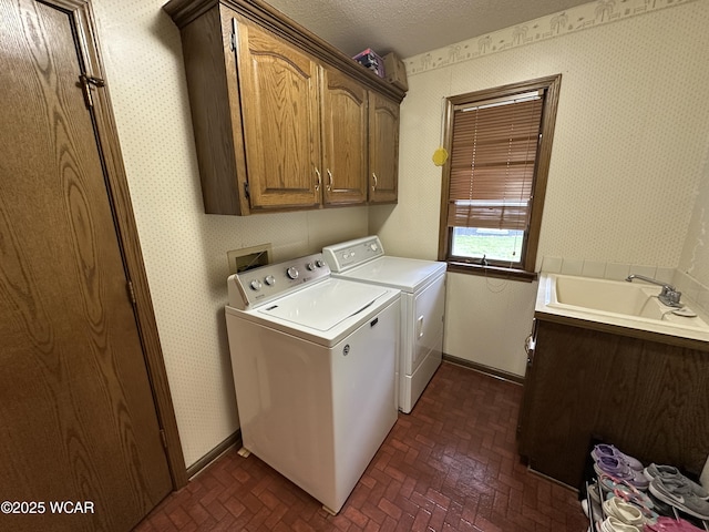 2969 Sands Rd, Lima, OH 45805 - laundry room featuring cabinet space, washer and dryer, brick patterned flooring, wallpapered walls, and baseboards