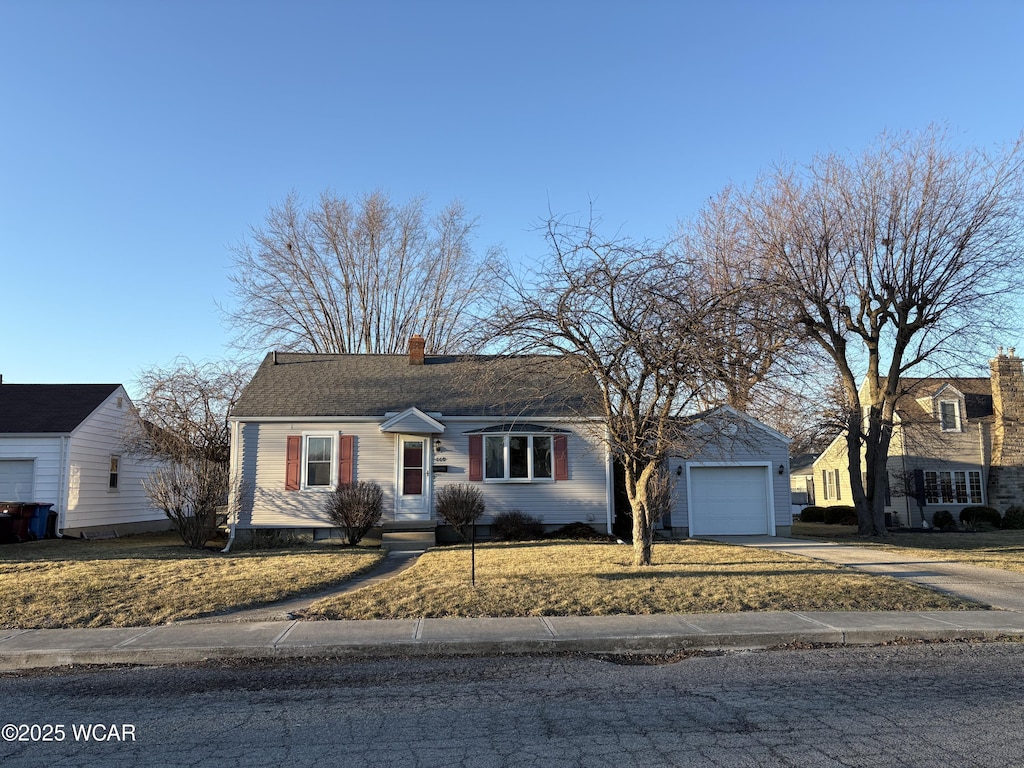 view of front of home featuring concrete driveway, a chimney, and an attached garage