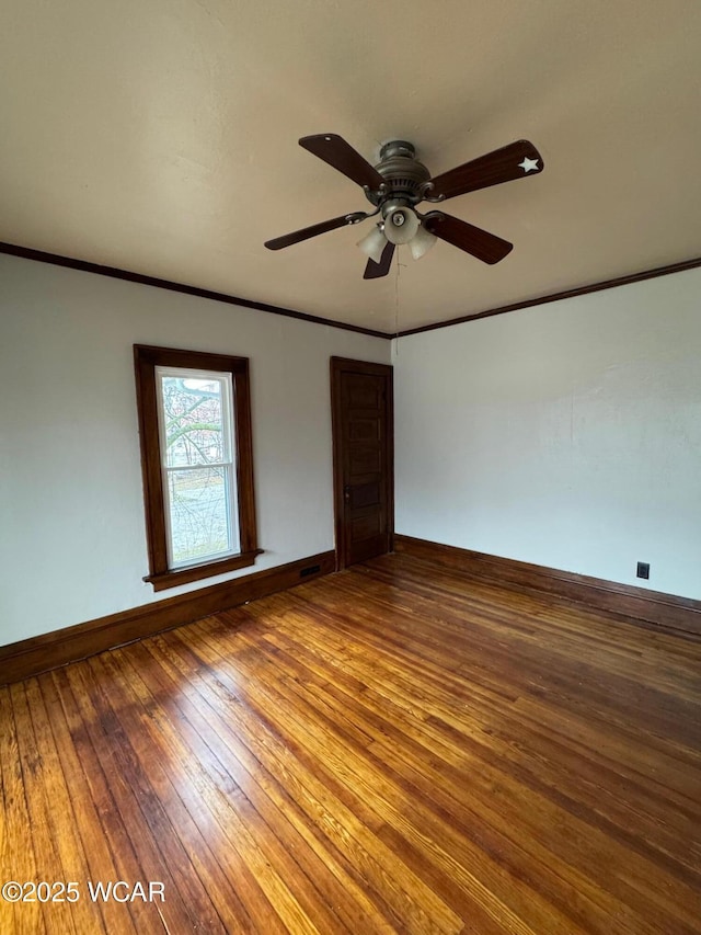 unfurnished room featuring hardwood / wood-style flooring, crown molding, and ceiling fan