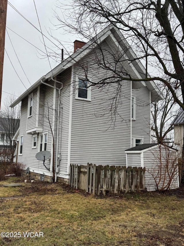 view of side of home with a lawn