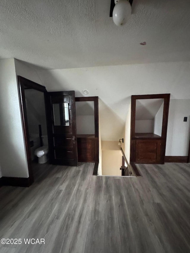 unfurnished bedroom with hardwood / wood-style floors and a textured ceiling