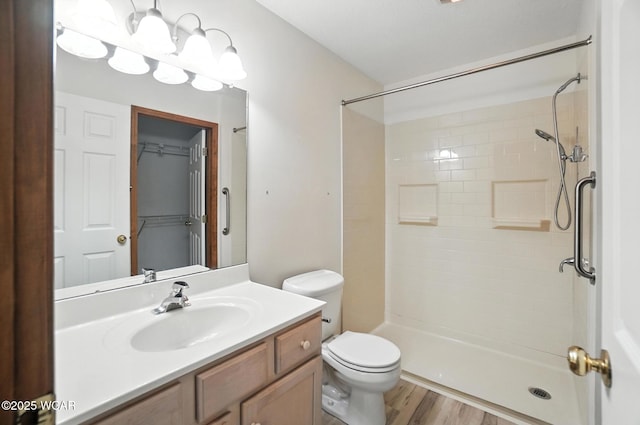 556 Westerly Dr, Lima, OH 45805 - full bathroom featuring vanity, a tile shower, and wood finished floors