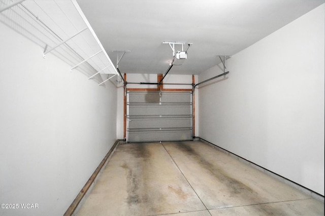 556 Westerly Dr, Lima, OH 45805 - garage featuring a garage door opener and baseboards