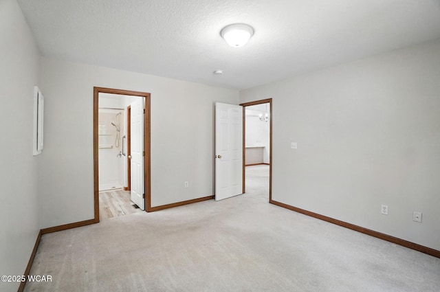 556 Westerly Dr, Lima, OH 45805 - unfurnished bedroom featuring light colored carpet and a textured ceiling
