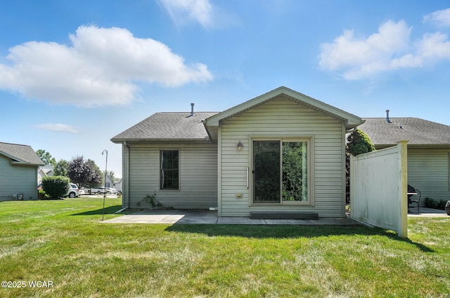 556 Westerly Dr, Lima, OH 45805 - back of property featuring a patio, a yard, and a shingled roof