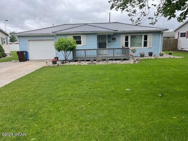 120 N Dr, Paulding, OH 45879 - single story home featuring concrete driveway, an attached garage, and a metal roof