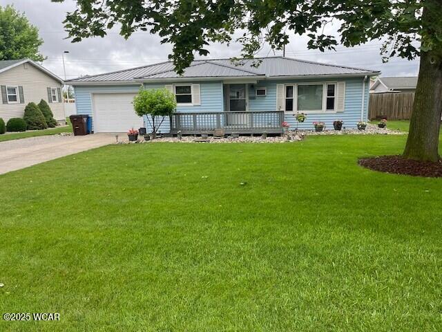120 N Dr, Paulding, OH 45879 - ranch-style home with a garage, concrete driveway, and a metal roof