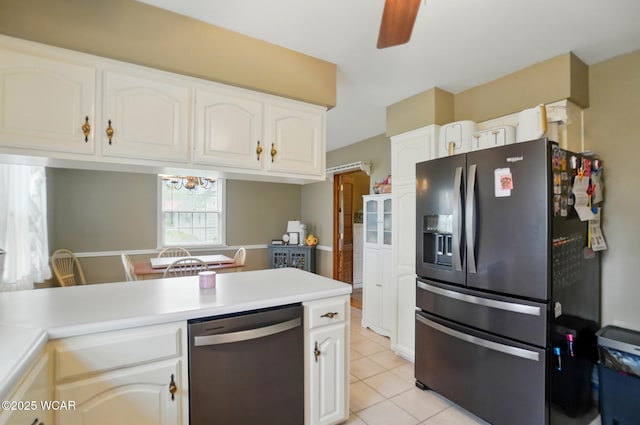 kitchen featuring appliances with stainless steel finishes, light tile patterned floors, light countertops, and white cabinetry