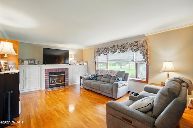 living room with ornamental molding, light wood finished floors, and a fireplace