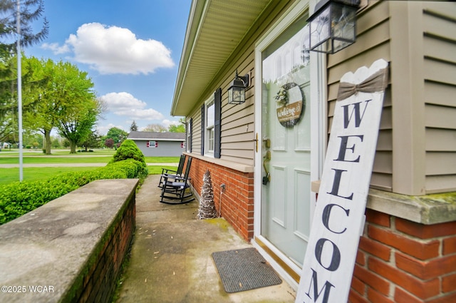 view of home's exterior featuring brick siding and covered porch