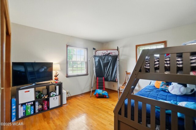 bedroom with wood finished floors and baseboards