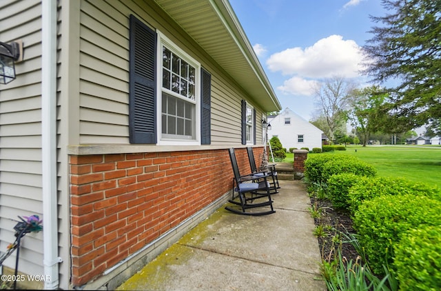 view of side of home with brick siding