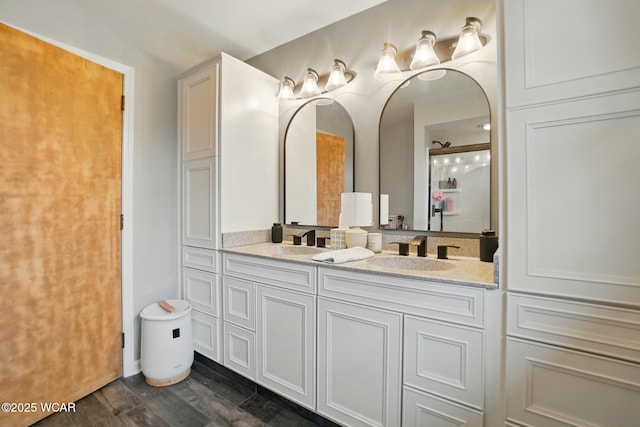 bathroom featuring wood finished floors and double vanity