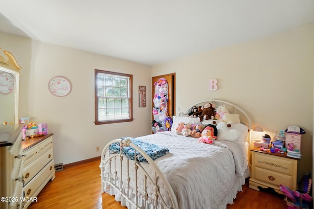bedroom featuring wood finished floors and baseboards