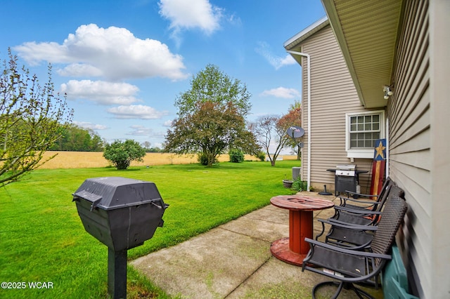 view of grassy yard featuring a fire pit and a patio area