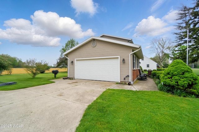 view of side of home featuring a lawn, a garage, and driveway