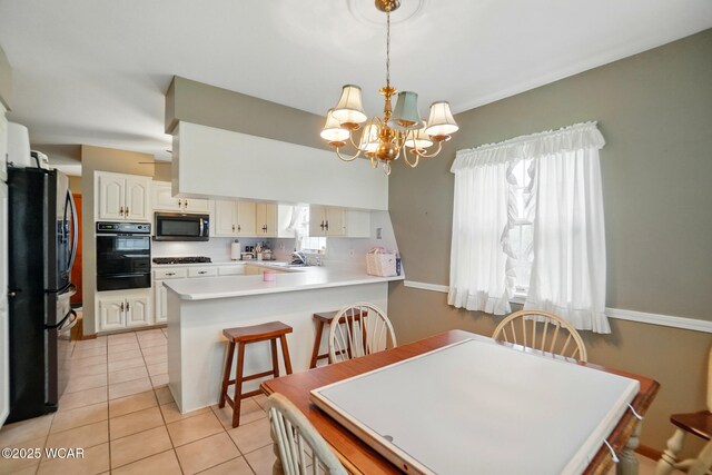 dining area featuring light tile patterned flooring, a chandelier, and plenty of natural light