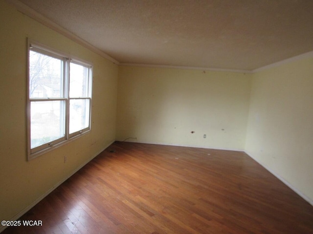 unfurnished room featuring hardwood / wood-style flooring and crown molding