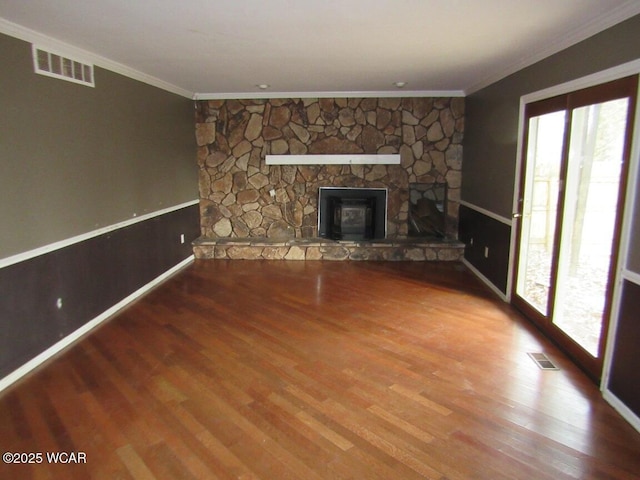 unfurnished living room with hardwood / wood-style flooring, a fireplace, and ornamental molding