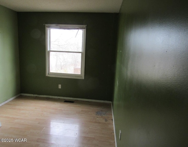 spare room featuring light hardwood / wood-style flooring