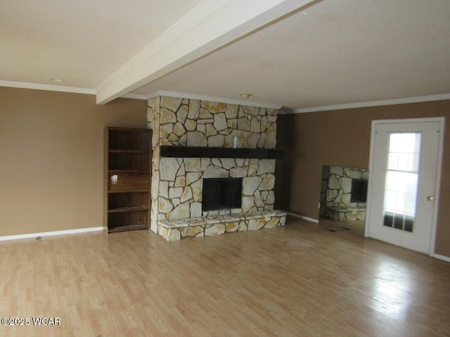 unfurnished living room with crown molding, a stone fireplace, light hardwood / wood-style flooring, and beamed ceiling