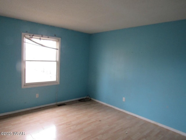 empty room with light hardwood / wood-style floors