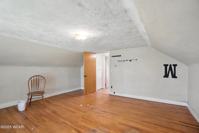 411 W Pattison Ave, Kenton, OH 43326 - bonus room featuring baseboards, a textured ceiling, wood finished floors, and lofted ceiling
