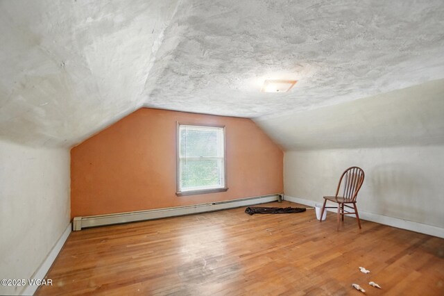 411 W Pattison Ave, Kenton, OH 43326 - bonus room with baseboard heating, wood finished floors, vaulted ceiling, and baseboards
