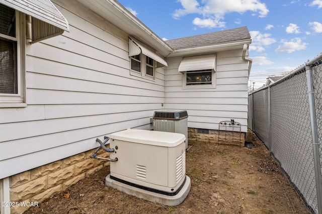 view of home's exterior featuring crawl space, a shingled roof, fence, and cooling unit