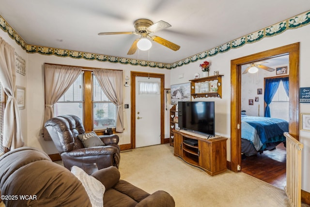 living room with ceiling fan and light colored carpet