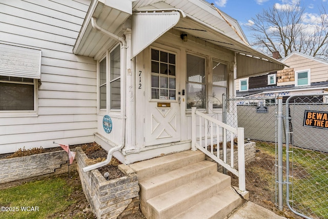 property entrance featuring a gate and fence